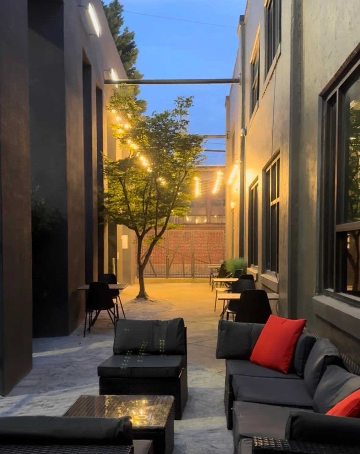 Evening patio lounge seating with string lights at Lee's Coffee