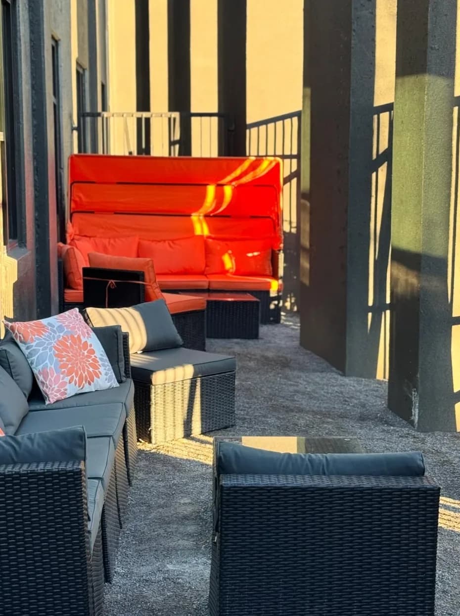 Outdoor patio lounge seating in golden afternoon light at Lee's Coffee